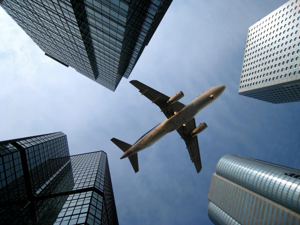 Airplane flying over buildings