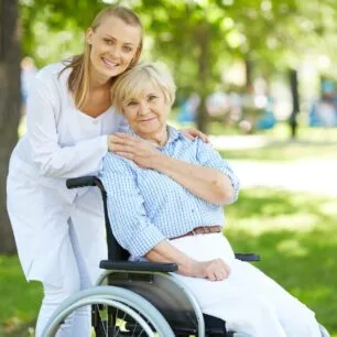 Elder care consultant taking an elderly person for a walk