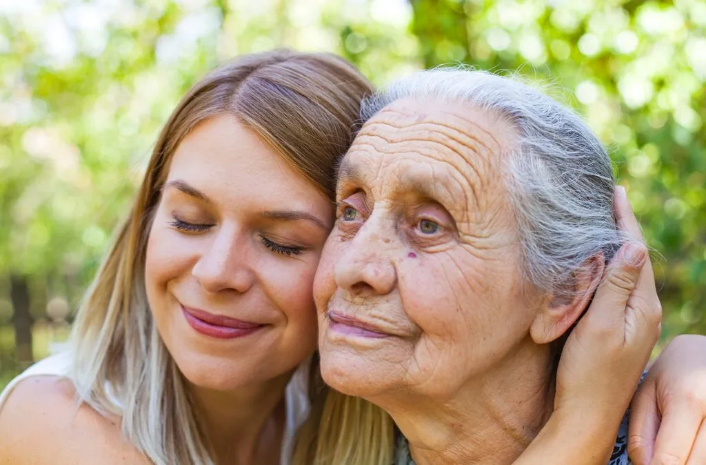 Caregiver using dementia care strategies to calm an elderly parent at home